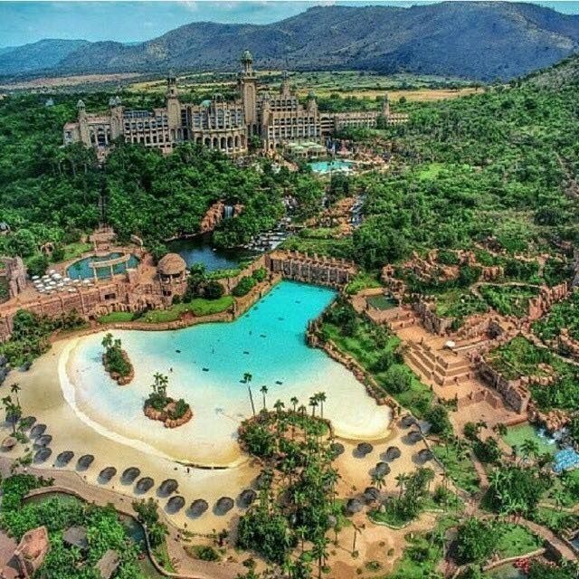 an aerial view of a resort with a pool and water park in the middle of it