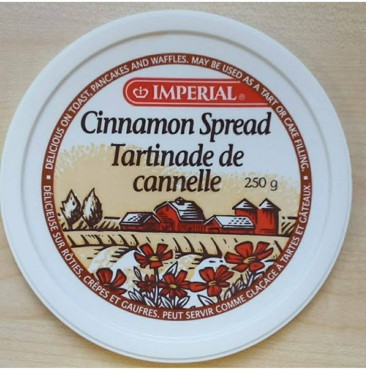 an empty jar of cinnamon spread sits on a table