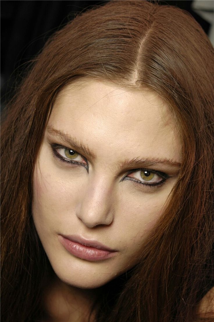 a woman with long brown hair and green eyes