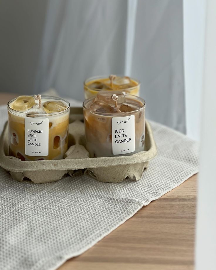 two candles sitting on top of a tray filled with food