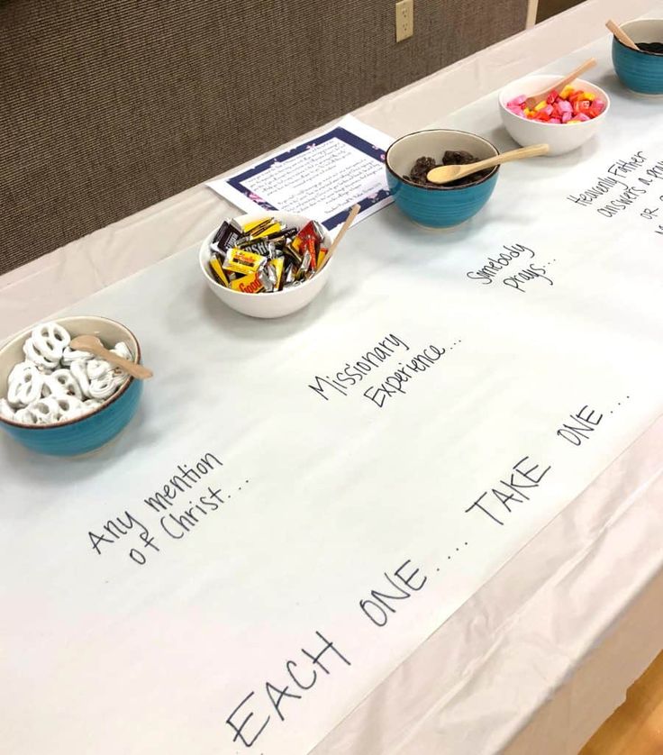 the table is set up with bowls of cereal and candy for each one take me