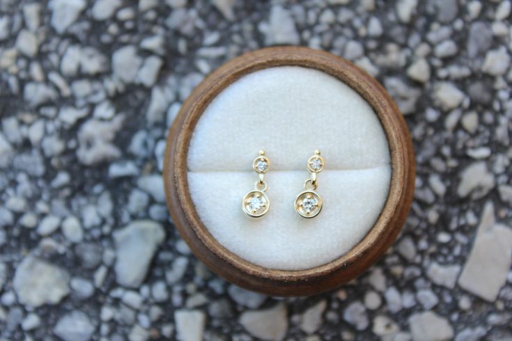 Lovely minimal 14k solid yellow gold .09 ctw diamond studs, perfect sparkly everyday look! * Handmade in the USA. * Gold KT: 14K solid yellow gold. * Primary gemstone: : 2 mm round diamond (.06 ctw). * Secondary Gemstone: 1.5 round diamond (.03 ctw). * Earring Closure: Screw Back. * Earring Style: Drop Studs. * Earring length: 11 mm approximately. * Setting Type: Prong Setting. * Additional Notes: This item can be customized. * Ready to ship. FREE SHIPPING! Dainty Everyday Diamond Earrings With Single Cut Diamonds, Dainty Everyday Diamond Earrings With Single Cut, Dainty Diamond Earrings With Single Cut Diamonds, Dainty 14k Gold Diamond Accented Earrings, Dainty Yellow Gold Diamond Earrings With Single Cut, Dainty 14k Gold Diamond Earrings With Accents, Dainty Yellow Gold Diamond Earrings With Diamond Accents, Dainty Yellow Gold Diamond Earrings With Accents, Dainty Diamond Earrings With Single Cut Diamonds For Wedding