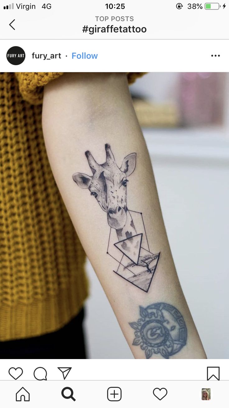 a giraffe tattoo on the left forearm and right arm with an origami envelope in it