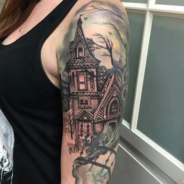 a woman with a house tattoo on her arm