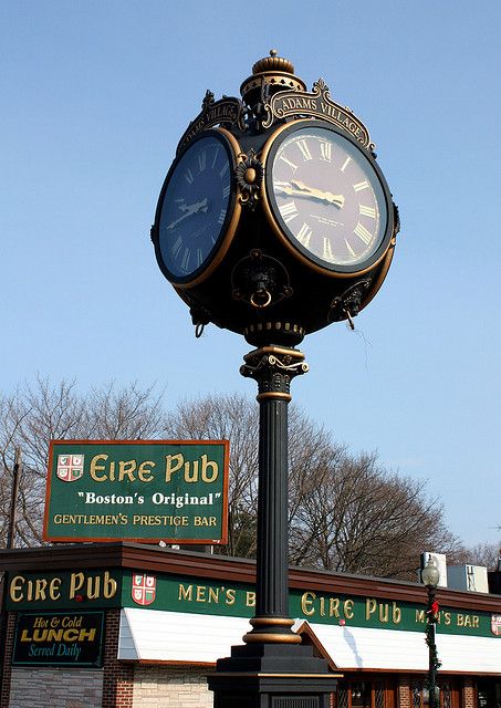 a clock on top of a pole in front of a store