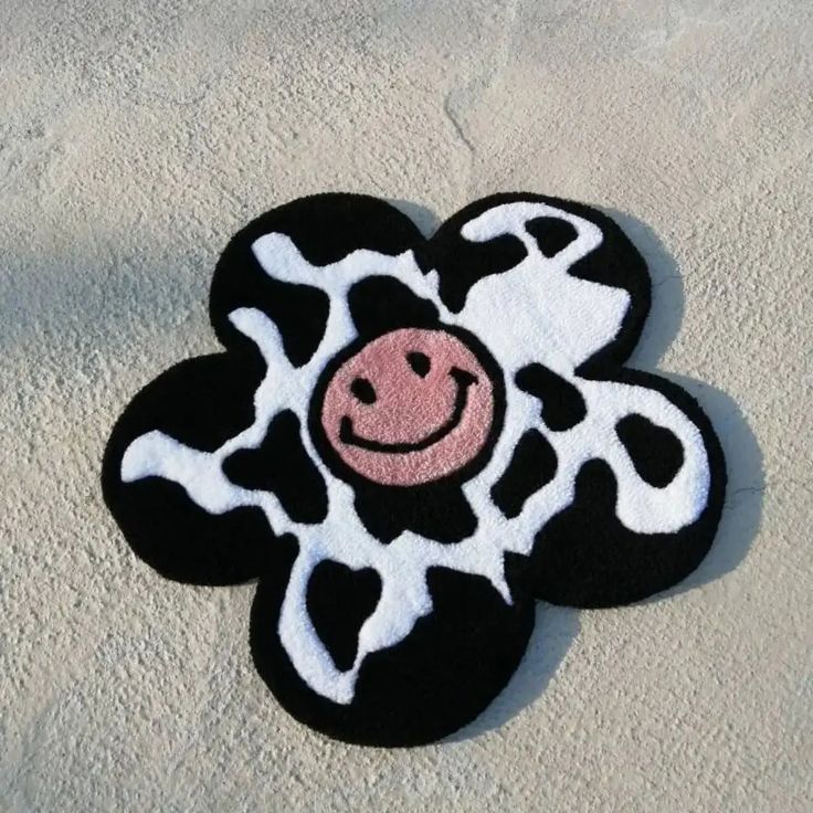 a black and white cow with a smile on it's face