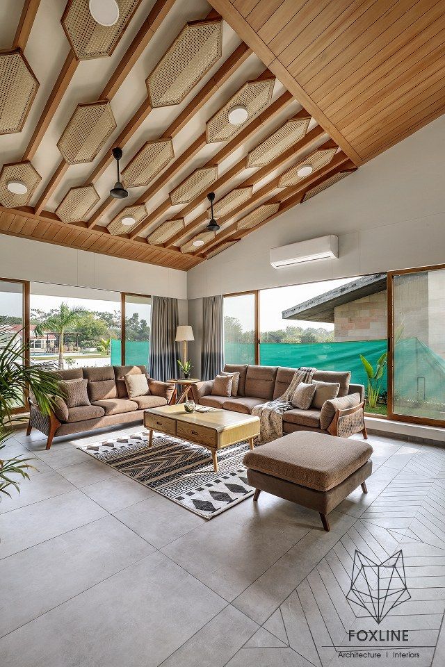 a large living room with lots of windows and furniture on the floor in front of it