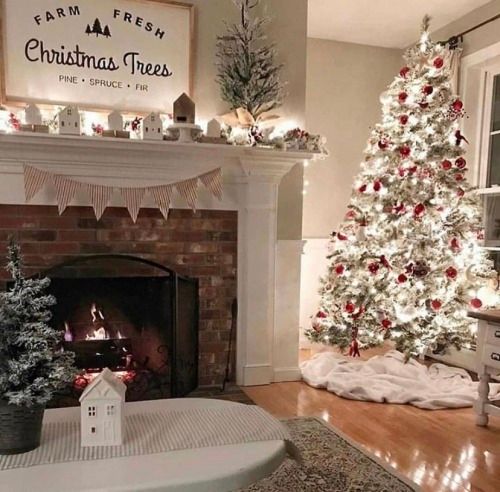 a living room with a christmas tree and fireplace