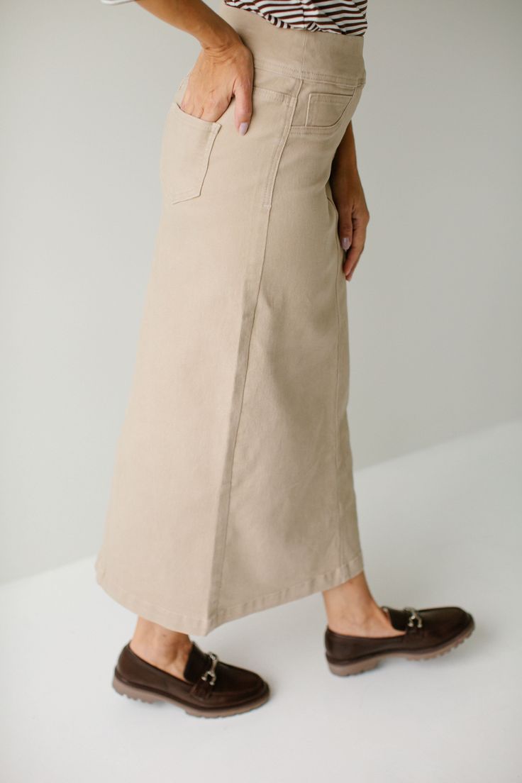 Simple style at its finest, the 'Sara' Denim Skirt was designed with your everyday life in mind! This classic denim skirt is made from a soft, stretch denim in a straight cut to ensure a modest and flattering fit, and is as comfy as they come! The details include a stretch waist band, faux front pockets, and functional back pockets and the khaki color is simple to pair with. Exclusively designed by us with you in mind! 97% Cotton, 3% Spandex Machine Wash Cold Hang or Lay Flat to Dry Do Not Bleac Relaxed Denim Skirt For Workwear In Fall, Casual Cotton Pencil Skirt For Fall, Casual Everyday Pencil Skirt, Fall Relaxed Straight Leg Denim Skirt, Relaxed Fit Straight Leg Denim Skirt For Fall, Mid-rise Cotton Relaxed Denim Skirt, Classic Mid-rise Denim Skirt For Spring, Relaxed Cotton Mid-rise Skirt, Mid-rise Relaxed Cotton Skirt