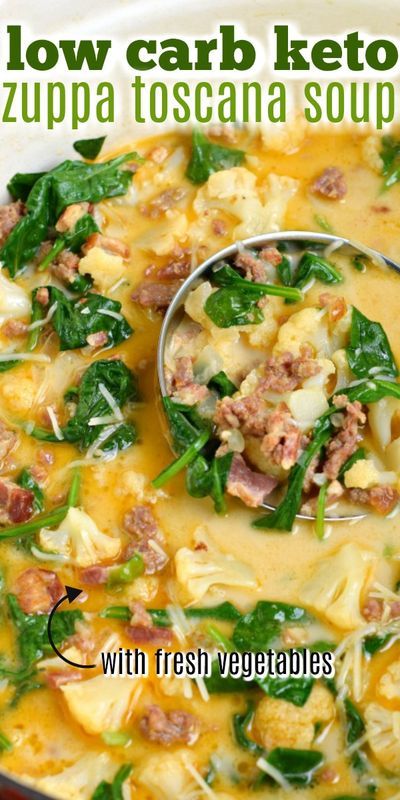 a ladle full of soup with spinach and meat in it, on top of a white plate