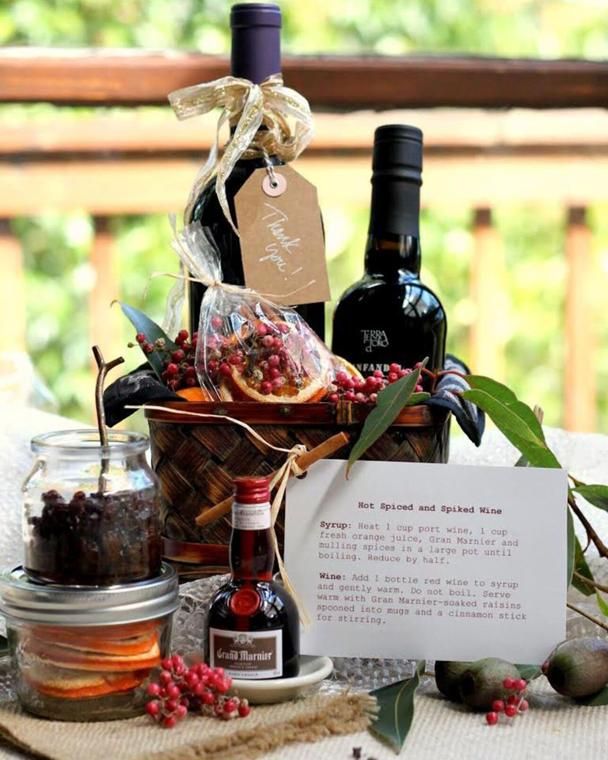 a table topped with bottles of wine and other items next to a sign that says,