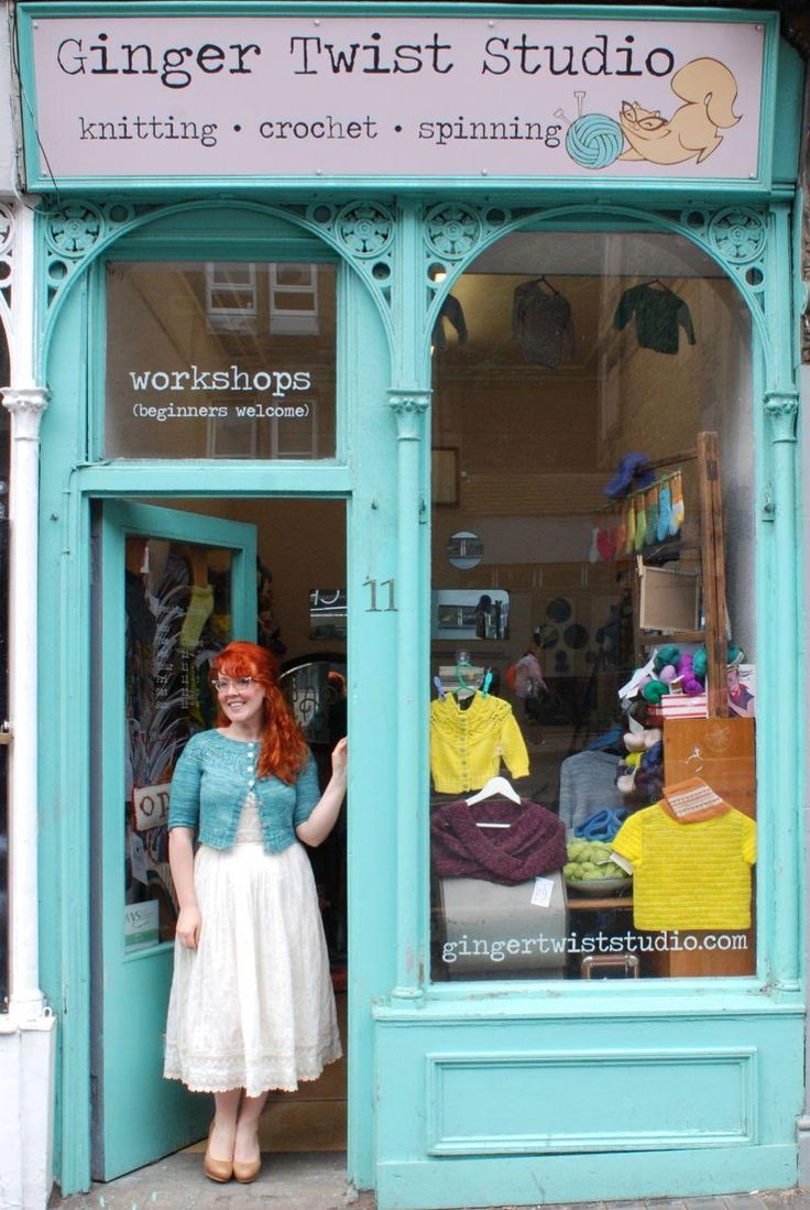 a woman standing in front of a sewing shop