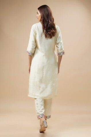 Ivory kurta with anchor thread embroidery in floral pattern on cutwork neckline. Paired with border embroidered pant and dupatta. - Aza Fashions Off White Silk Sets With Floral Embroidery, Off White Floral Embroidered Traditional Wear For Reception, Off White Traditional Wear With Floral Embroidery For Reception, Cream Embroidered Cotton Silk Set, Cream Straight Kurta Set With Floral Embroidery, Elegant Traditional Wear With Embroidered Border In Off White, White Silk Sets With Embroidered Border, Elegant Off White Traditional Wear With Embroidered Border, Fitted Off White Kurta With Floral Embroidery