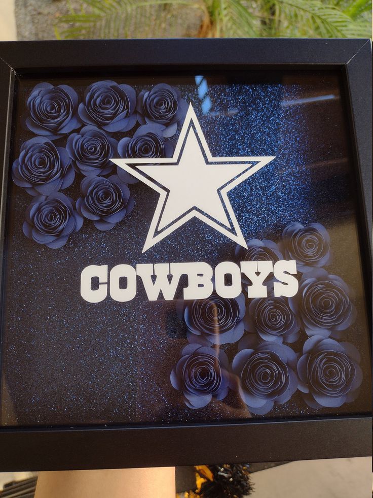 the shadow of a cowboy's star is shown in a shadow box with roses