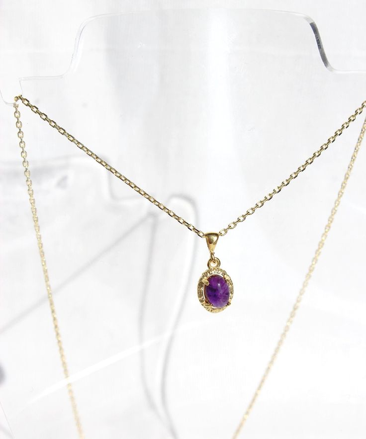 14K Gold Plated Oval Amethyst Necklace Elegant and refined, this natural amethyst necklace exudes timeless sophistication. The oval stone is set in 14k gold plated sterling silver, enhancing its beauty and elegance. This necklace offers a minimalist yet sophisticated look. Complete your ensemble by pairing it with the matching earrings for a coordinated and refined style statement. Amethyst, known for its rich purple hue, symbolizes clarity and tranquility, fostering a profound sense of calm and Oval Amethyst Birthstone Necklaces, Oval Amethyst Necklace With Natural Stones, Oval Purple Necklaces With Natural Stones, Purple Birthstone Oval Pendant Necklace, Purple Oval Gemstone Necklace, Oval Lavender Gemstone Necklace, Purple Gemstone Necklace With Oval Pendant, Amethyst Oval Pendant Necklace For Gift, Amethyst Necklaces For Gifts, Fine Jewelry Style