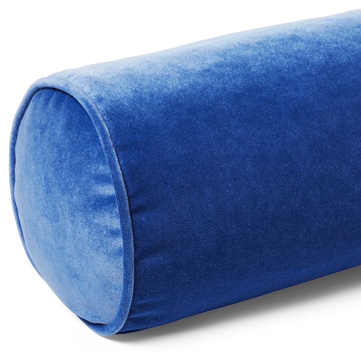 a large blue pillow sitting on top of a white floor