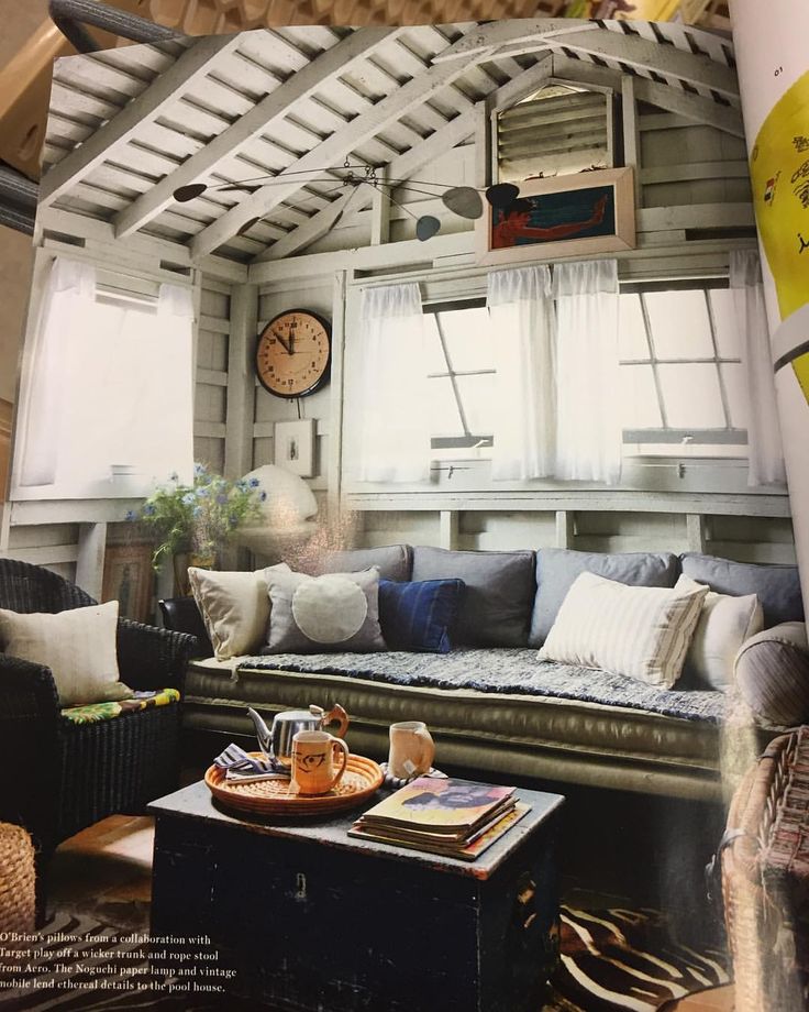 a living room filled with furniture and lots of windows