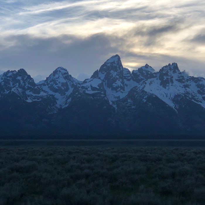 the mountains are covered in snow as the sky is dark blue and there is no image to describe