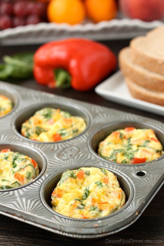 there are many muffins in the pan on the table next to some fruit