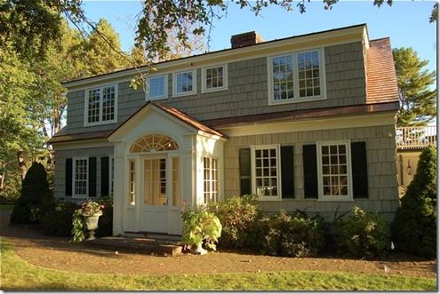 a house with white trim and black shutters