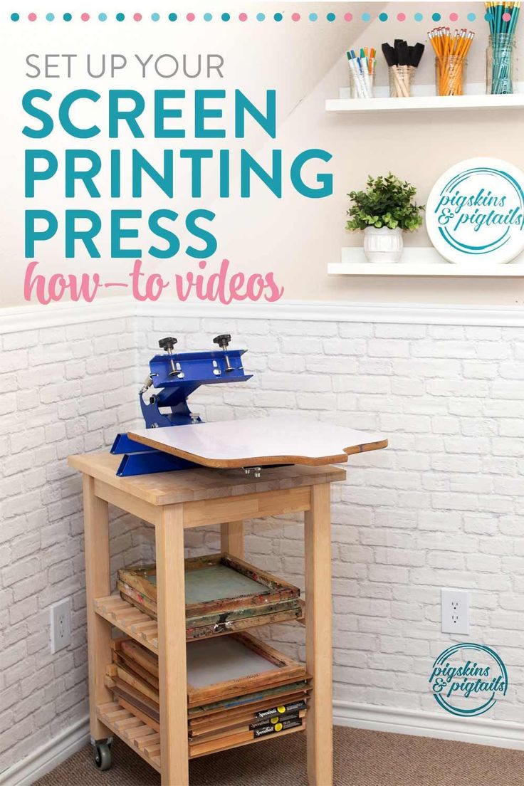 a sewing machine sitting on top of a wooden table next to a white brick wall