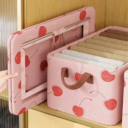 a child's closet with pink and red storage bins