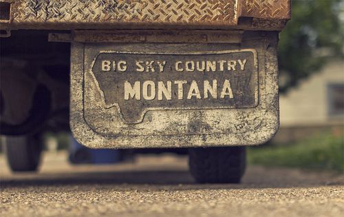 the back end of an old truck that says big sky country montana