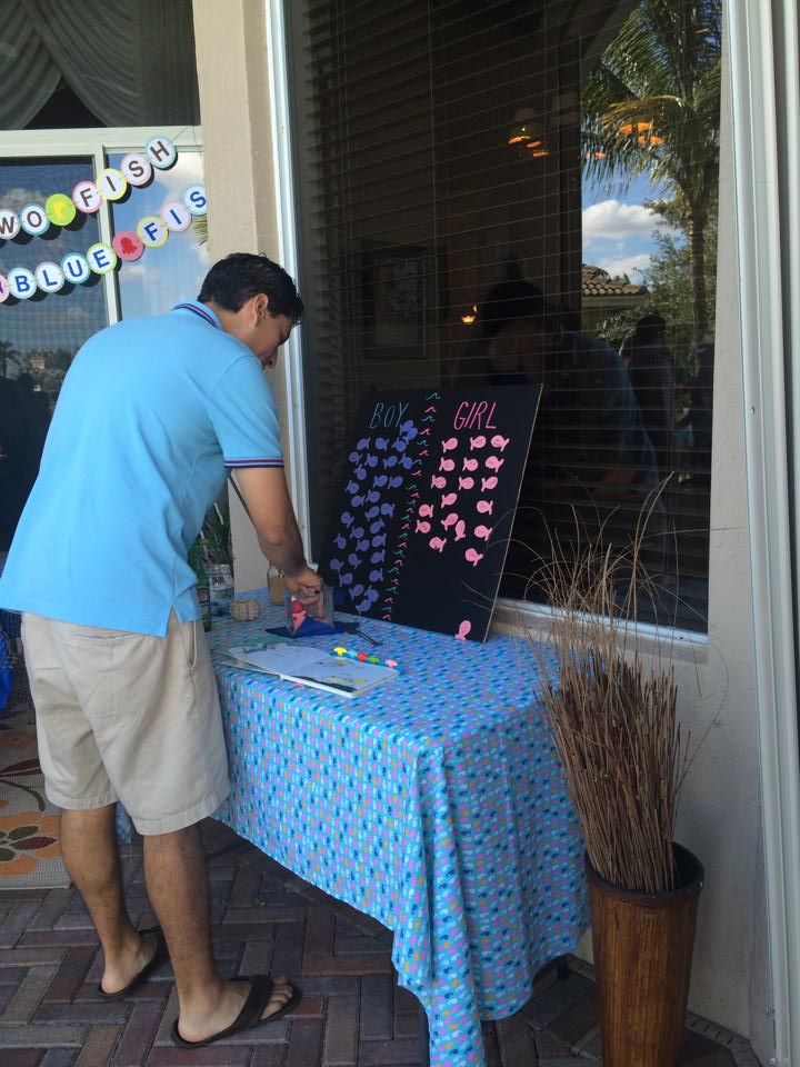 a man standing next to a table with writing on it