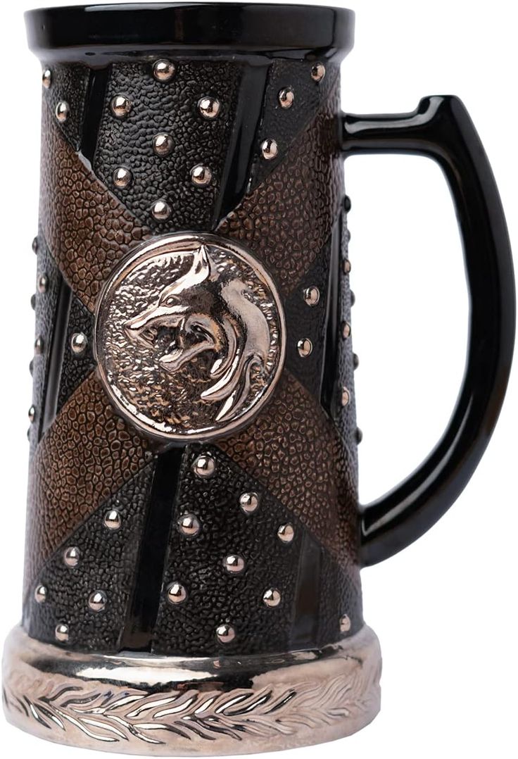 a black and brown beer mug with a lion on it's face in the center