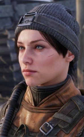 a close up of a person wearing a hat and looking off to the side with an evil look on her face