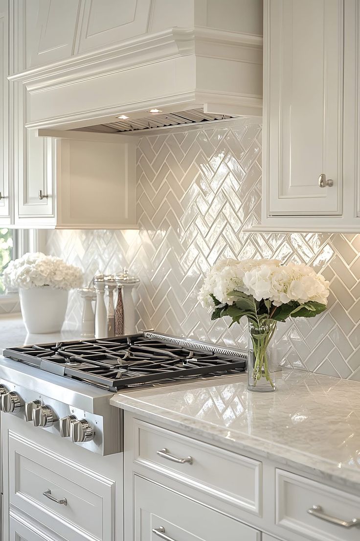 a kitchen with white cabinets and marble counter tops is pictured in this image, there are flowers on the stove