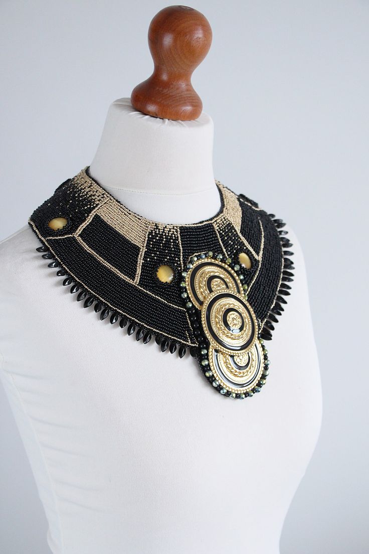 This is extra large black statement necklace made of two colors: black and gold. Large black collar necklace inspired by Art Deco Cleopatra costume. Yes, this is my favorite Art deco Cleopatra costume necklace. Perfect for black outfit, fits well on top on the garment and open shoulder dress. Collar necklace is adjustable, fits of each size of neck. Chunky necklace made only of seed beads and glass beads. It's huge, it's unique and one of a kind statement jewelry piece. Very festive and solemn s Elegant Adjustable Beaded Chain Bib Necklaces, Elegant Adjustable Bib Necklace With Beaded Chain, Gold Bib Necklace With Colorful Beads, Elegant Gold Choker With Colorful Beads, Unique Black Beaded Necklace For Party, Unique Black Beads Necklace For Party, Unique Black Beaded Jewelry For Party, Unique Black Beaded Choker, Unique Black Beaded Chain Necklace