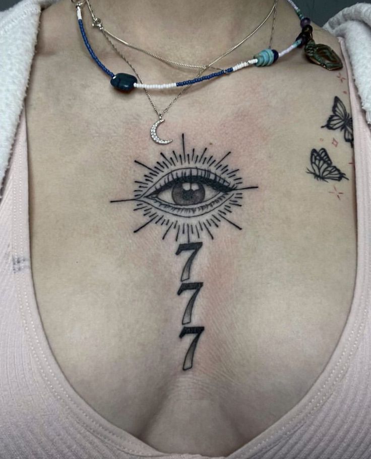 a woman with an all seeing eye tattoo on her chest