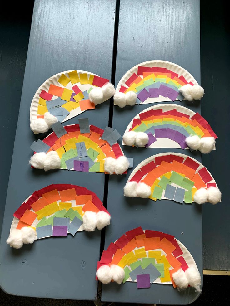 paper plate rainbows are arranged on a table