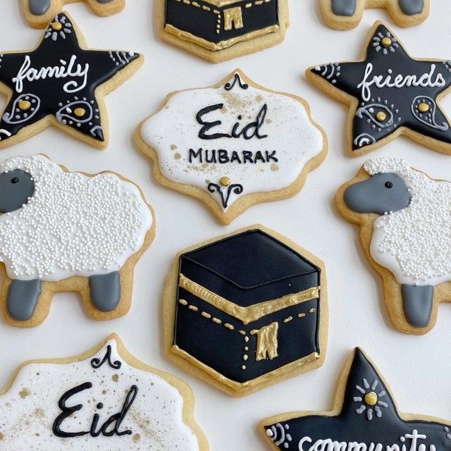 decorated cookies in the shape of sheeps and stars with names on them, including an eid mubarak