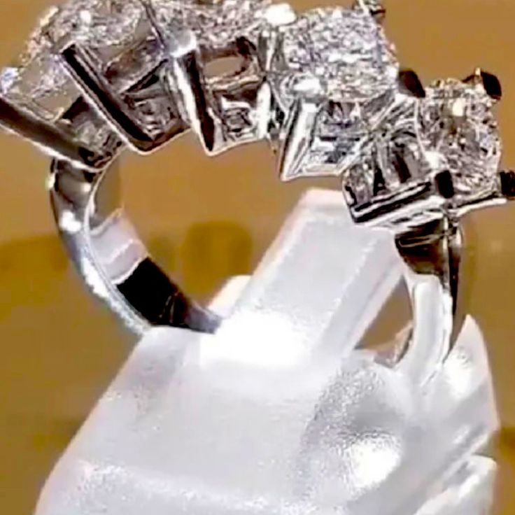 a diamond ring sitting on top of a white object