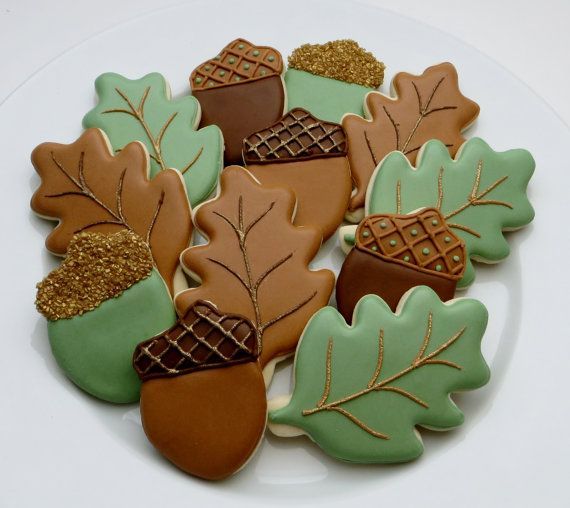 cookies decorated with leaves and acorns on a plate