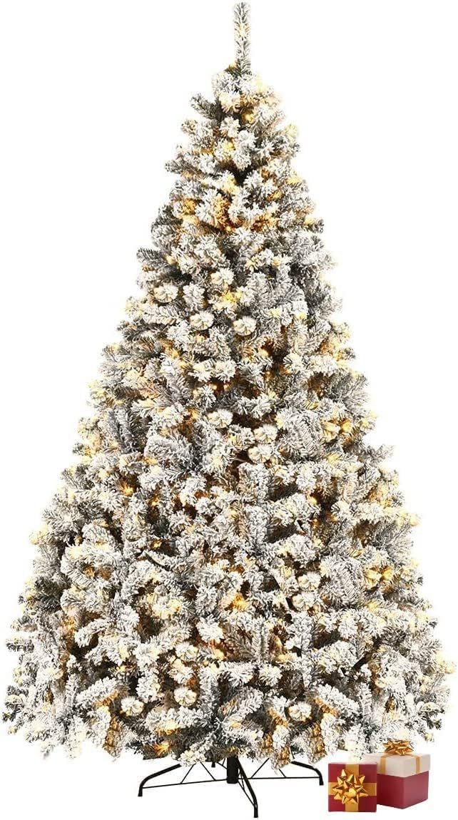 a white christmas tree with presents under it