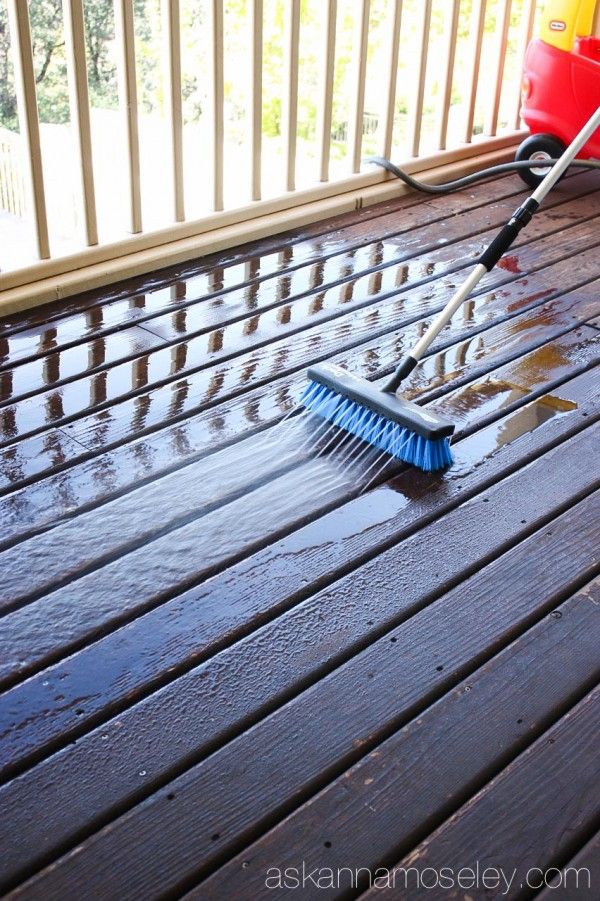 two brooms are laying on the deck with water