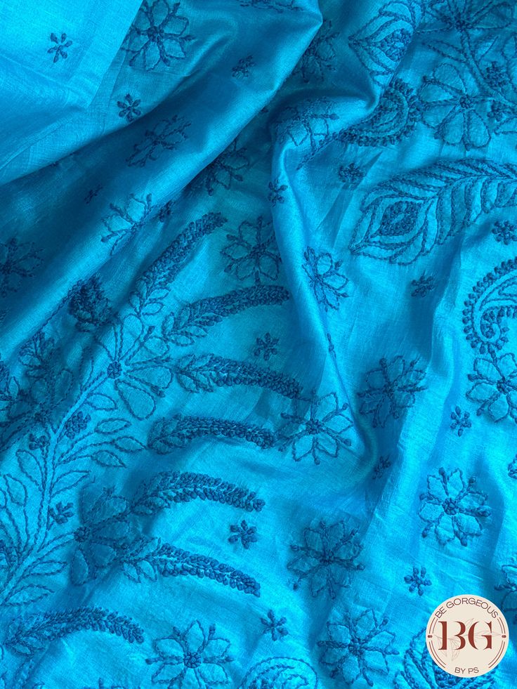 This exquisite blue silk piece showcases intricate Chikankari embroidery, a handcrafted technique that dates back to the Mughal era. Designed to elevate any outfit, this one-of-a-kind piece exudes timeless elegance and luxury. Experience the art of Chikankari and indulge in the finest craftsmanship with this stunning silk creation. Chikankari on Silk - Blue Saree comes with a blouse piece. Fall and pico done. Fully stitched blouse shown in pictures is optional and can be purchased seperately from our blouses and croptops section. For saree video please connect with us on whatsapp @469-937-0606 Ready to be shipped in USA from San Diego, California. All pictures are original pictures. Colors may slightly vary due to pic resolution. Blue Slub Silk Dupatta With Resham Embroidery, Elegant Blue Slub Silk Dupatta, Blue Slub Silk Dupatta, Blue Festive Slub Silk Traditional Wear, Indigo Traditional Wear With Chikankari For Festive Occasions, Blue Slub Silk Dupatta For Transitional Season, Transitional Season Blue Slub Silk Dupatta, Festive Blue Slub Silk Traditional Wear, Blue Slub Silk Traditional Wear For Festive Occasions