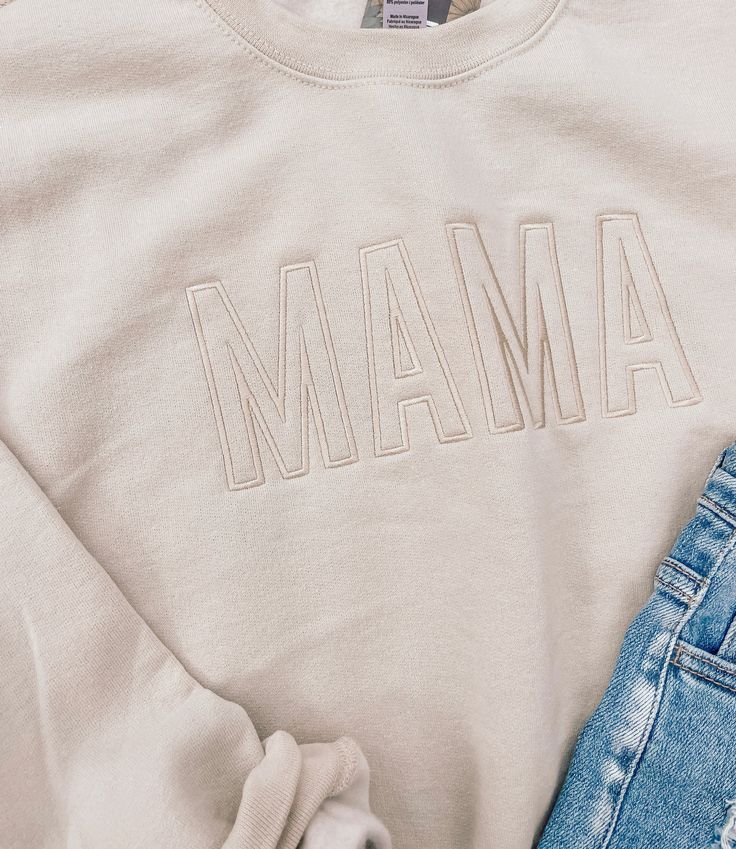 How adorable are these new Mama Embroidered Sweatshirts? 8 oz., 50% USA cotton, 50% polyester Pill-resistant air jet yarn Made with 50% sustainably and fairly grown USA cotton Cotton Sweatshirt With Embroidered Text, Relaxed Fit, Relaxed Fit Cotton Sweatshirt With Embroidered Text, Basic Cotton Sweatshirt For Spring, Casual Embroidered Organic Cotton Tops, Soft-washed Cotton Sweater For Spring, Relaxed Fit Cotton Sweater With Embroidered Logo, Casual Tops With Custom Embroidery And Relaxed Fit, Casual Tops With Custom Embroidery In Relaxed Fit, Cotton Sweatshirt With Embroidered Graphics And Relaxed Fit