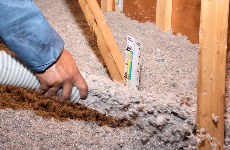 a man is pouring cement into the floor with a hose in his hand and sand coming out of it