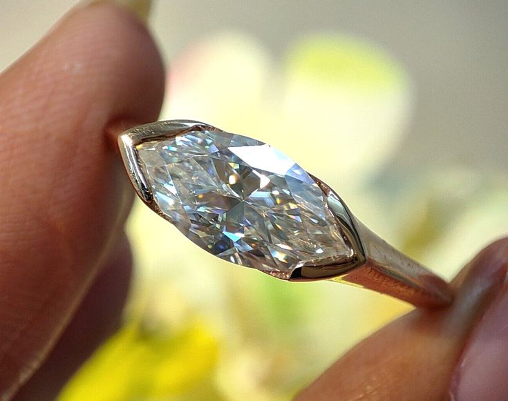 a close up of a person holding a diamond