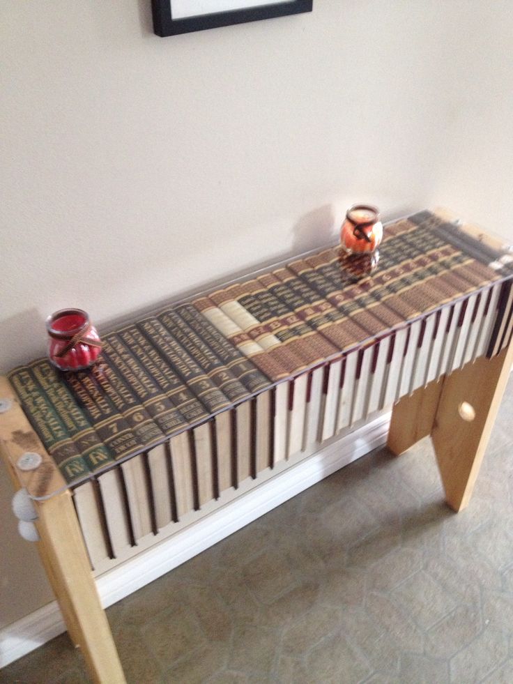 a wooden table with two vases on it and a painting hanging above the table