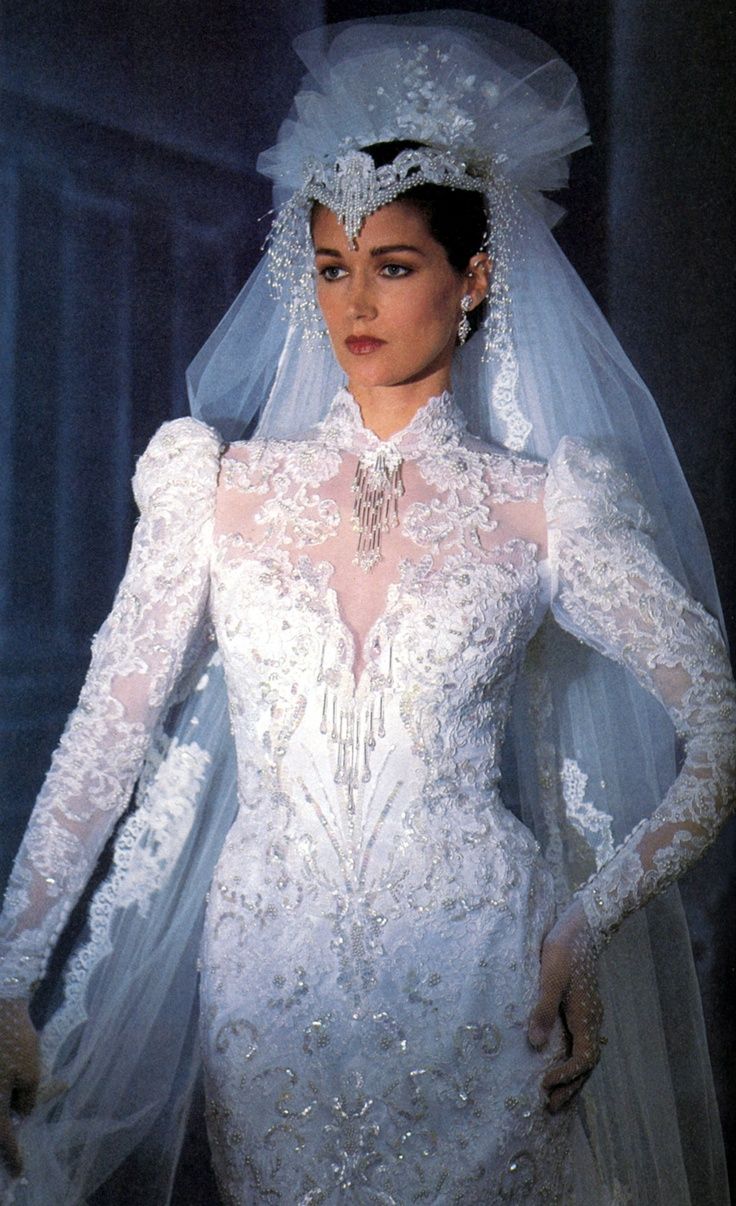 a woman in a white wedding gown and veil