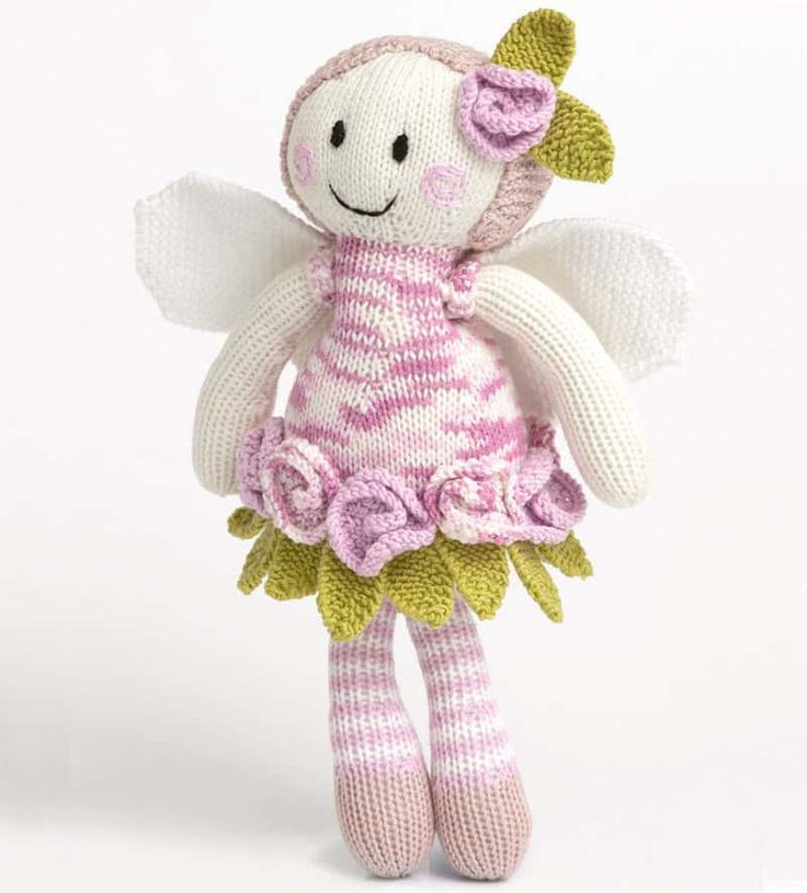 a knitted stuffed animal with pink and white stripes on it's body, sitting in front of a white background