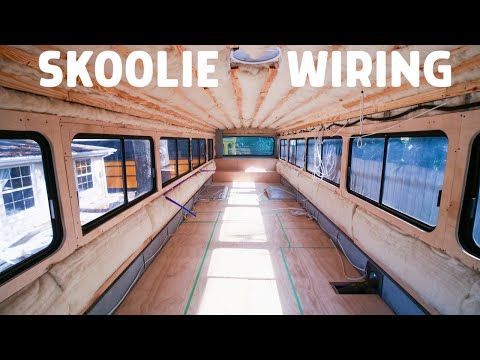 the inside of a train car with windows on each side and words skoolie wiring above it