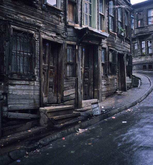 an old run down street with wooden buildings