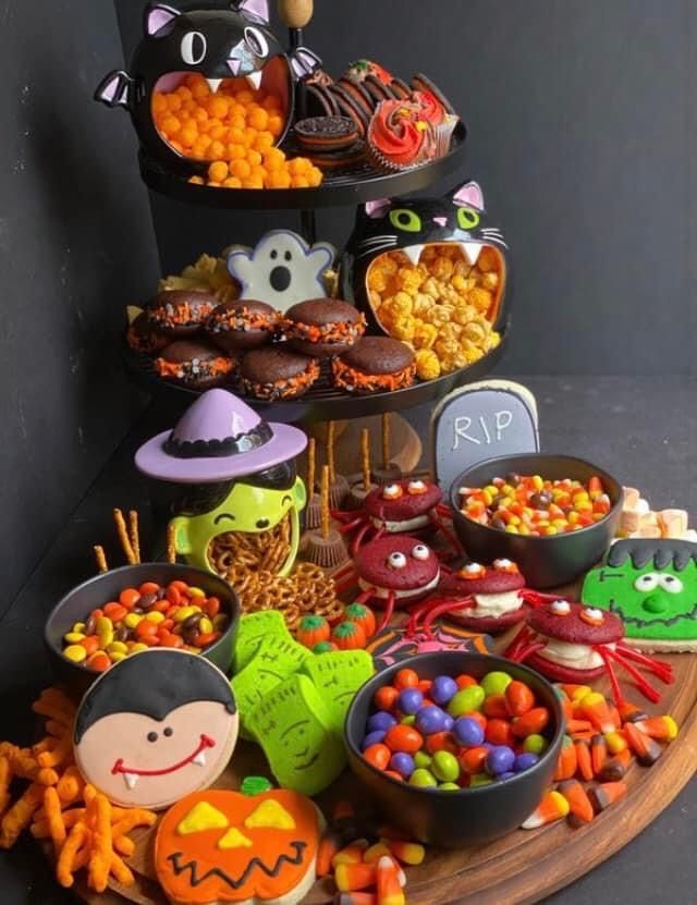 a table topped with lots of halloween treats