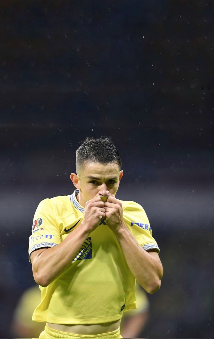 a soccer player with his hands clasped in prayer